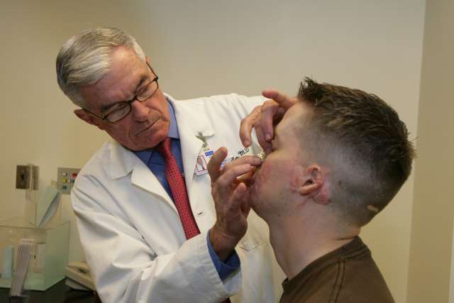 A photo of Dr. Timothy Miller with an Operation Mend patient.