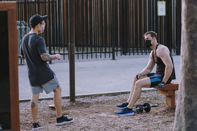 Men with face coverings in park