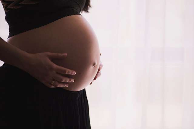 Profile photo of pregnant woman's belly