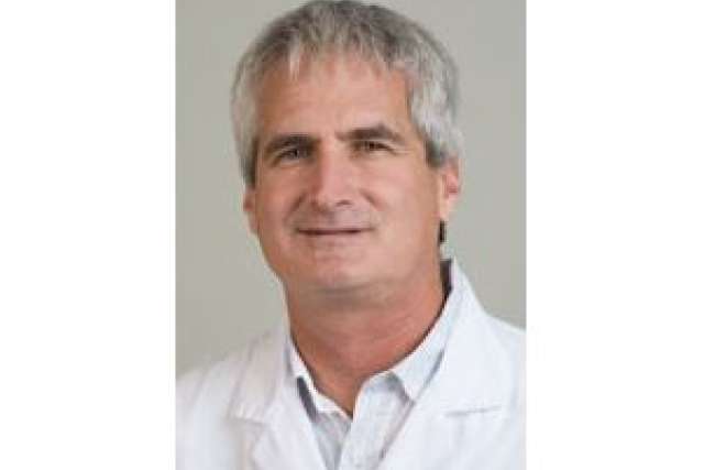 Man in a lab coat, possibly a scientist or medical professional.