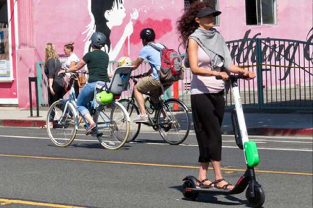 Woman riding Lime scooter