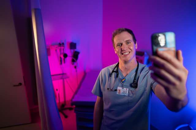 Doctor in scrubs with phone