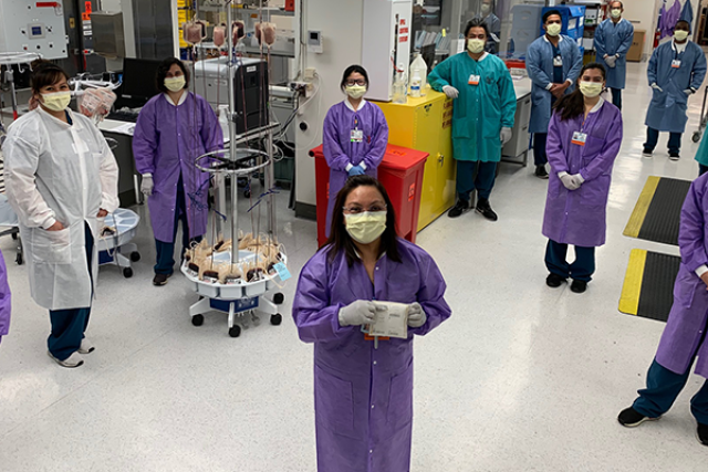 a group of UCLA Covid healthcare workers in lab wearing PPE such as gowns, gloves, and masks.