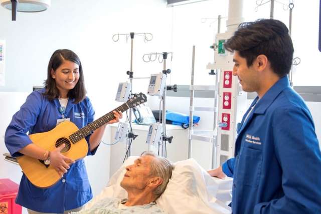 Volunteer musicians playing to patient.