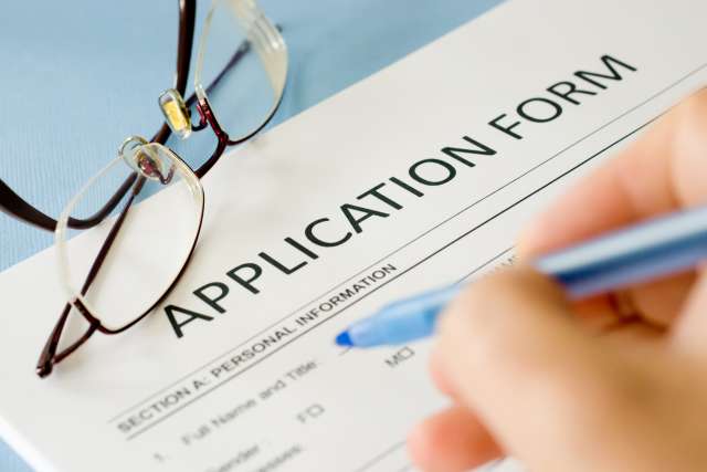 Person filling out an application form