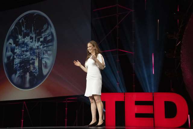 A speaker presents on stage.