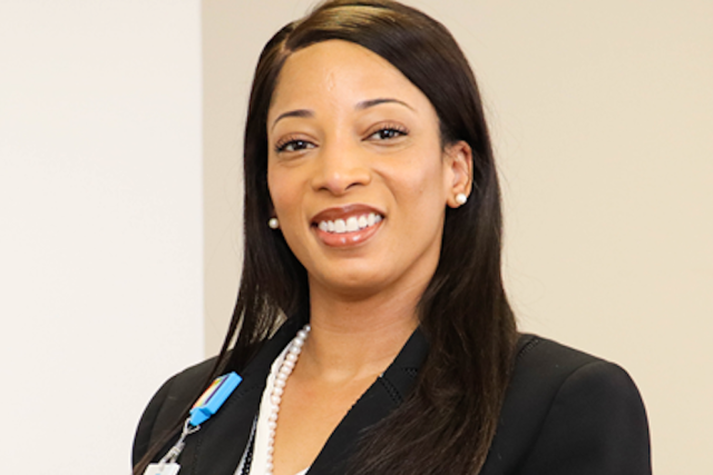 Batiste Brown headshot wearing a white button up shirt and black suit jacket.