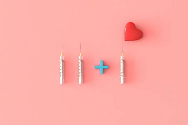 Three syringes, blue plus sign and red heart
