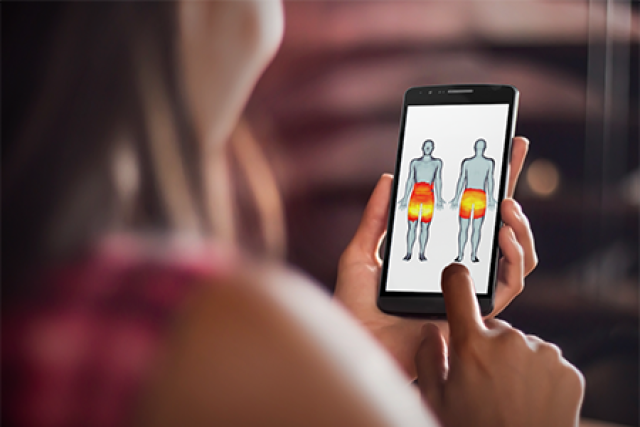 Woman holding a phone with an image of human's front and back, highlighting some pain points.