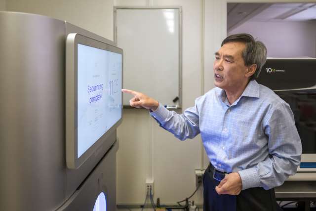 Man pointing at flat computer monitor screen