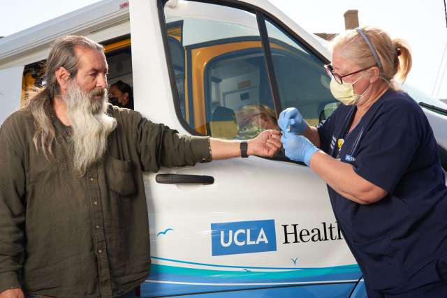 Nurse treating a homeless patient