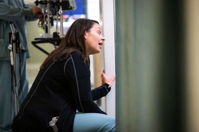 Karleen Wray kneeling down and speaking to someone out of view