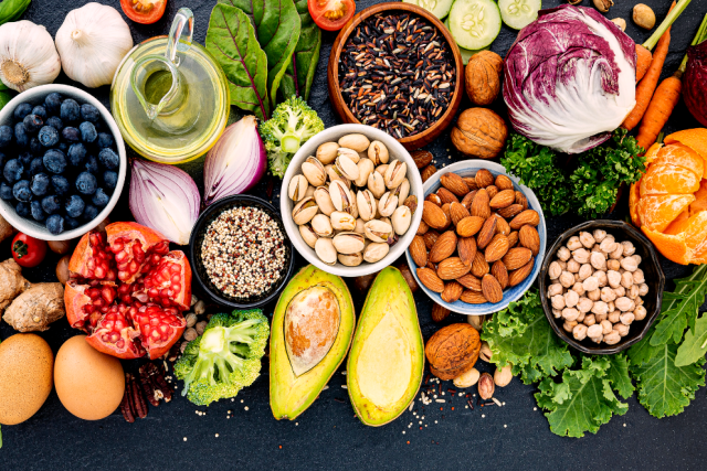 a table filled with different produce such as eggs, avocado, blueberries, etc.
