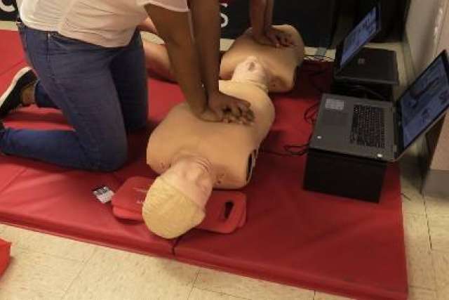 Students practice CPR in a mannequin. (Photo courtesy of the American Heart Association)