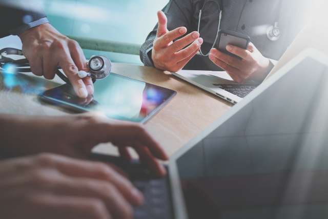Group of people collaborating with tablets