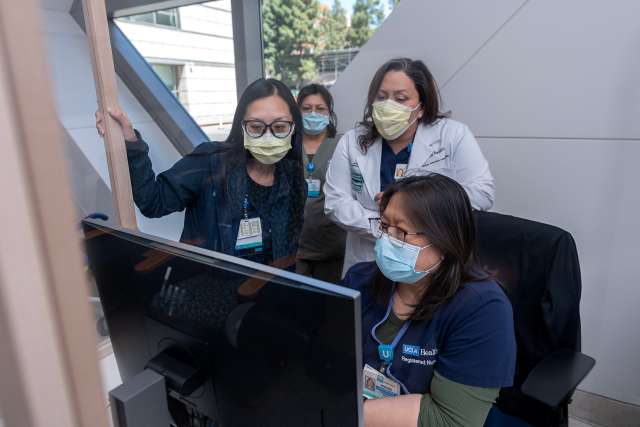 Group of nurses reviewing a computer screen