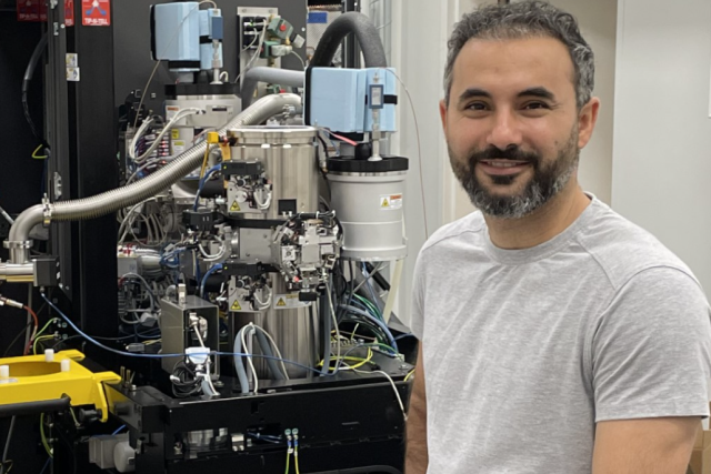 Navid Bavi stands next to equipment in his UCLA laboratory.