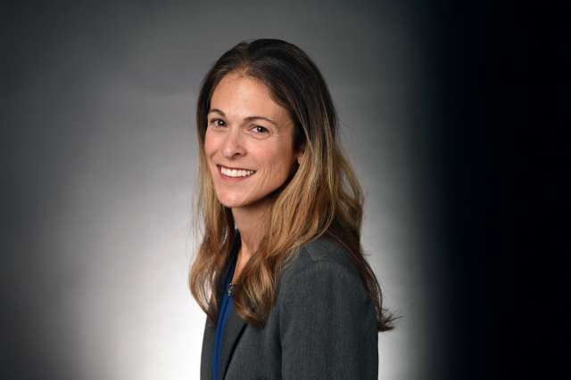 Professional headshot of Dr. Melissa Lechner in blazer with long brown hair