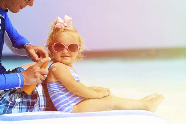 Young child at the beach on a hot day