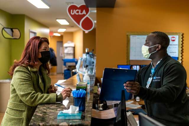checks in with hospital lab technician Gregory Domond