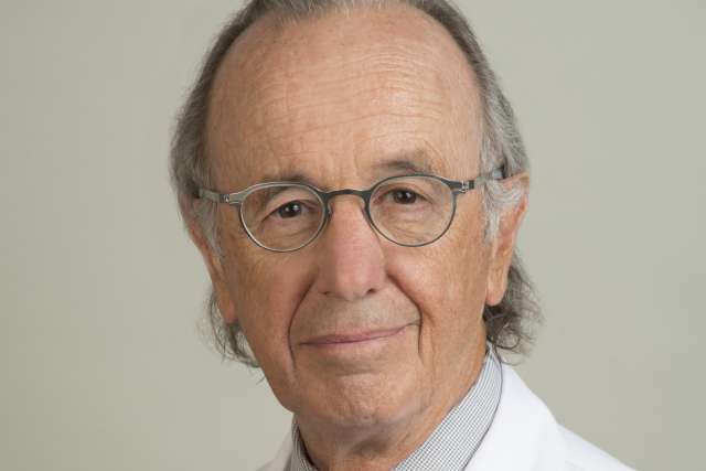 Gabriel M. Danovitch, MD wearing white coat and tie, glasses