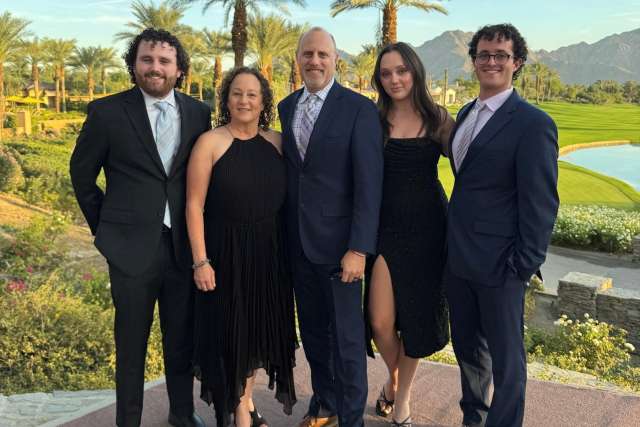 Ellen Pollack stands with her family.