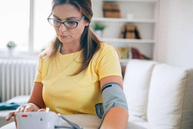 Woman measuring her blood pressure