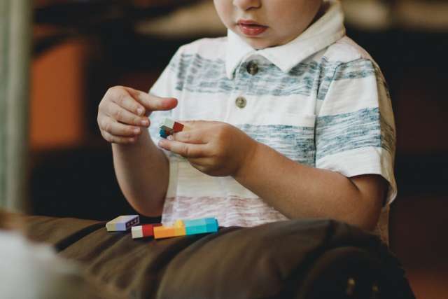 Boy plays with blocks