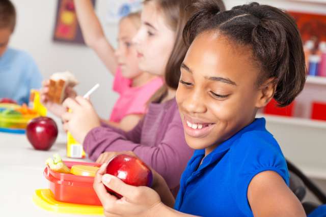 child eating lunch in school