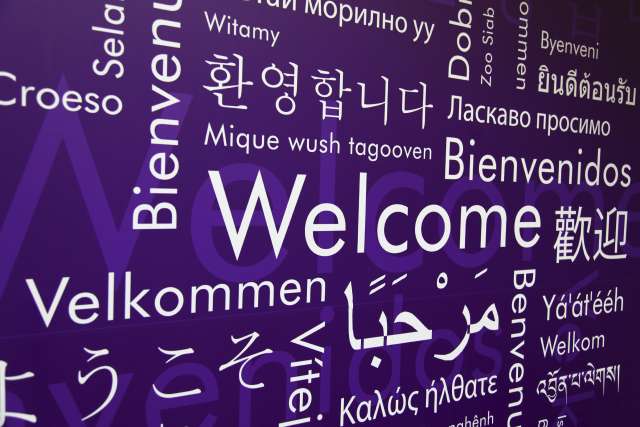 A sign shows the word "Welcome" translated into several different languages.