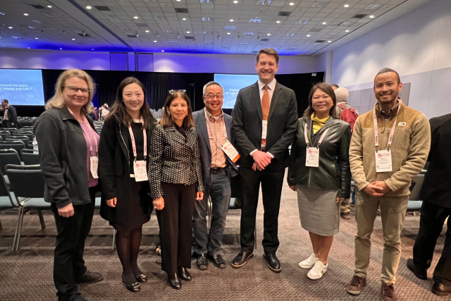 Group of 7 smiling UCLA and CIRM team members at a convention, including Drs. Kadyk, Zhang, Creasey, Okamura, Aldave, Millan, and Chung.
