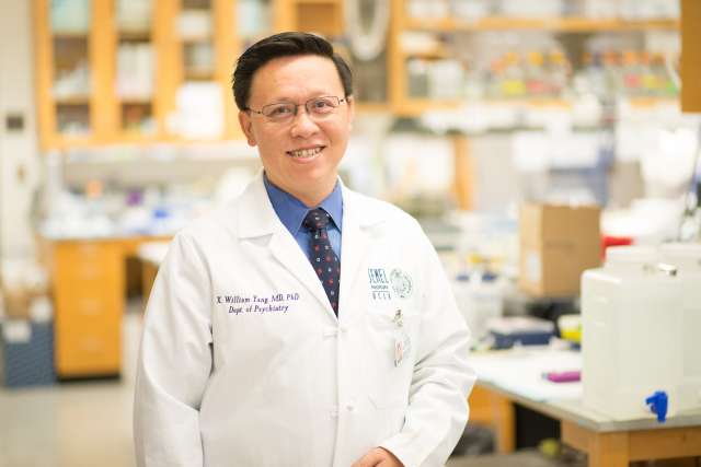 Dr. Xiangdong William Yang stands in his laboratory at UCLA Health.