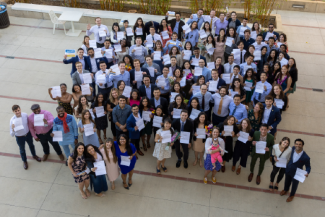 UCLA medical students celebrate Match Day 2022, holding envelopes and cheering in Switzer Plaza at the David Geffen School of Medicine.