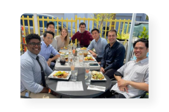 Eight members of the class of 2024 having lunch together.