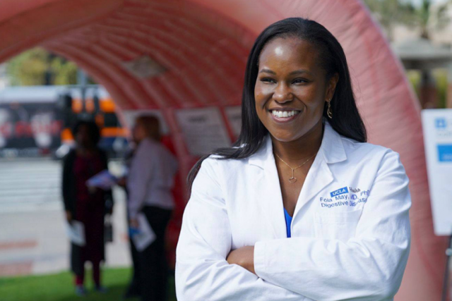 Dr. Folasade May , UCLA Health gastroenterologist, wearing a white lab coat