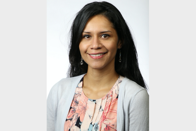 Dr. Maria Garcia‑Jimenez, director of Oncology Research at UCLA‑Olive View, poses for her headshot in a gray sweater and floral blouse