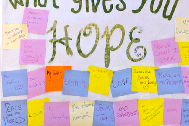 UCLA Health staff members write messages of hope and kindness on colorful sticky notes during a stress-relief event.