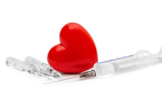 Red heart with syringe and glass ampoules