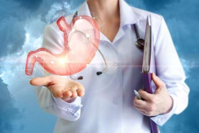 Image of a doctor holding a floating stomach in hand