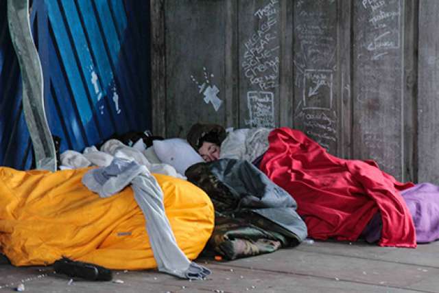 Homeless woman sleeping on the street