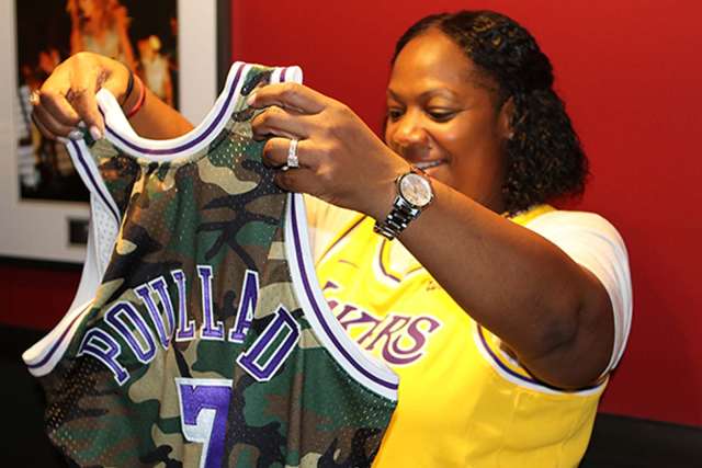 Yolanda Poullard looking at her custom made Lakers uniform.
