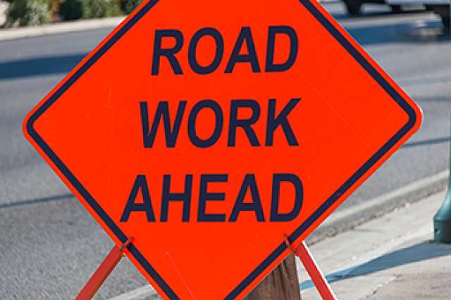 Orange Road Work Ahead traffic sign