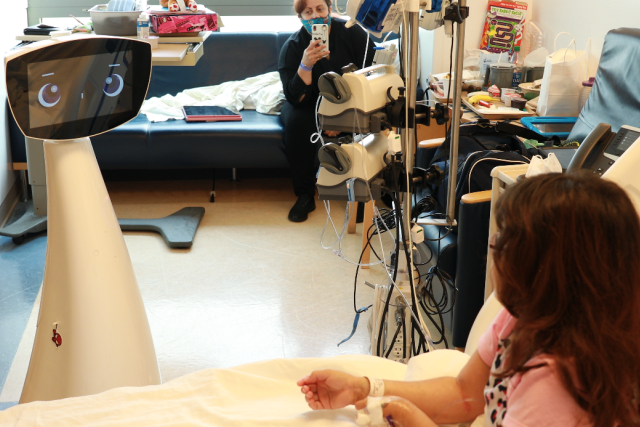 Robin the AI robot with expressive eyes and a friendly smile, designed to comfort pediatric patients at UCLA Mattel Children’s Hospital.