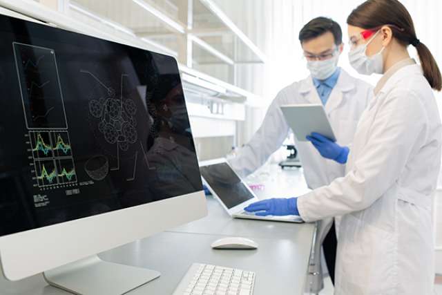 Scientists using computers in laboratory