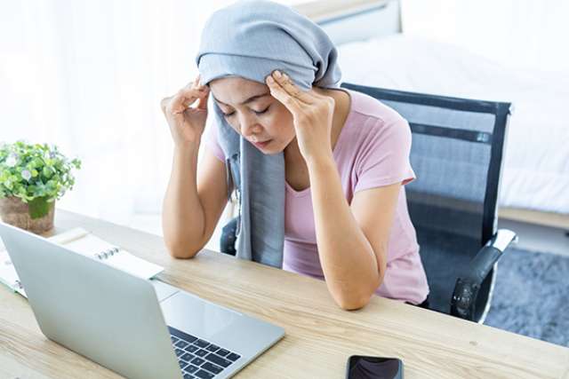 Woman with headscarf at computer