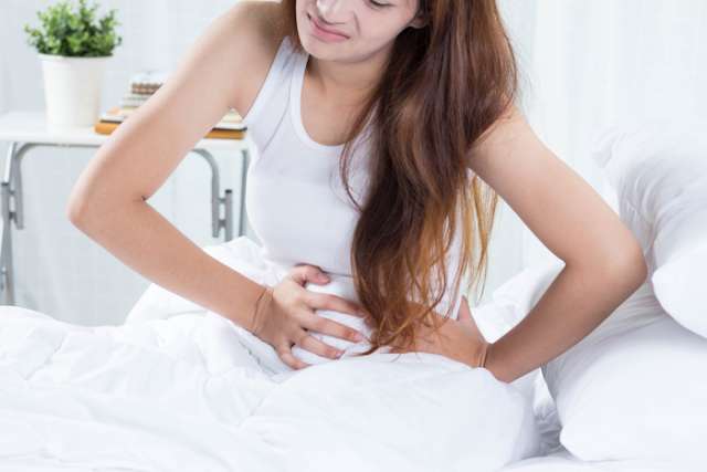 Woman experiencing abdominal pain