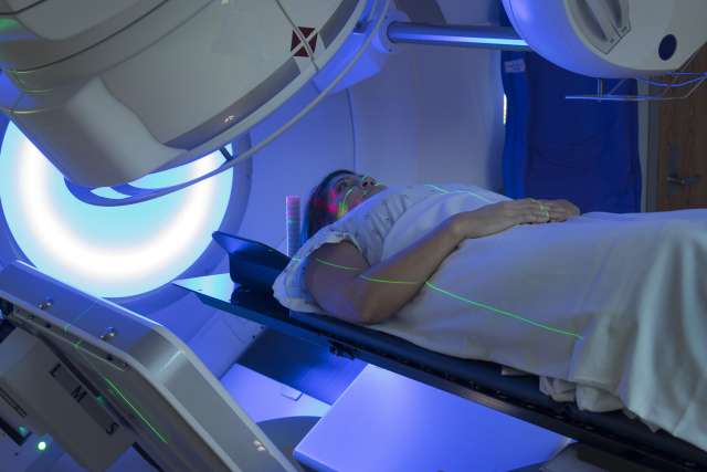 Woman undergoing radiation oncology treatment