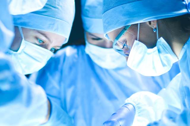 Surgery team at work on operating table