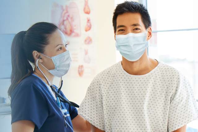 Asian patient with doctor wearing masks
