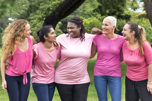Breast cancer survivors standing strong together